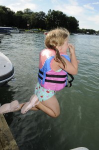 Girl jumping off dock